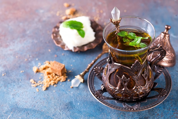 Bowl with Turkish cotton candy Pismaniye and black tea with mint