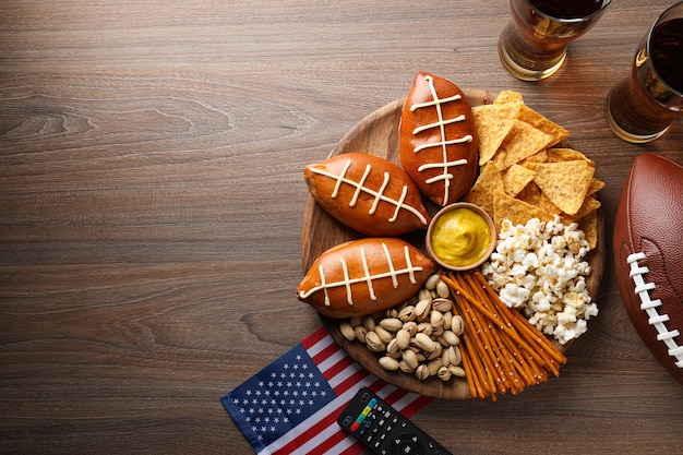 A bowl with various snacks a remote control and an American flag