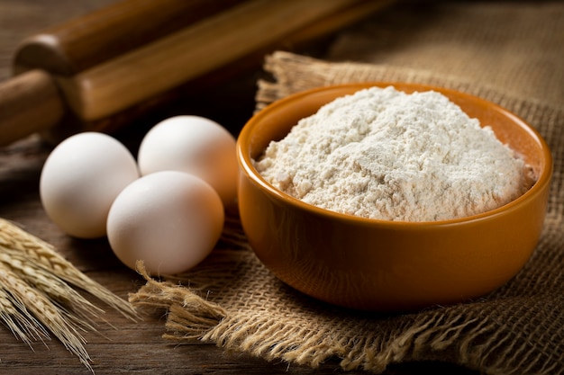 Bowl with wheat flour on the table