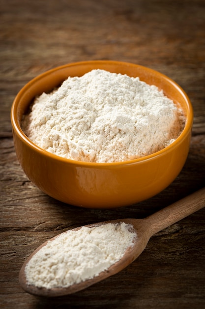 Bowl with wheat flour on the table