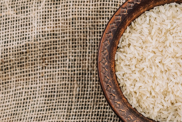 Photo bowl with white rice on linen cloth