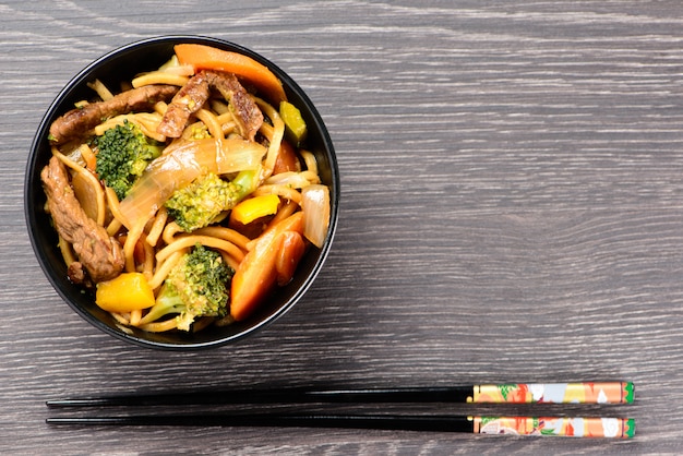 Bowl with yakisoba and hashi