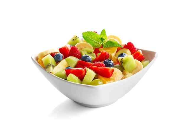 Bowl with yummy fruit salad isolated on white