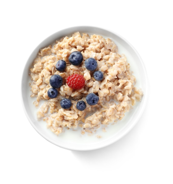 Bowl with yummy oatmeal and berries isolated