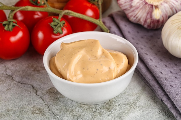 Bowl of Yellow cream grill sauce for burger