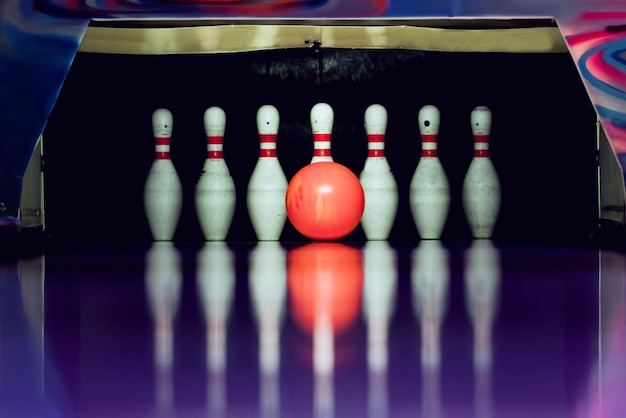 Photo bowling ball is going to hit skittles