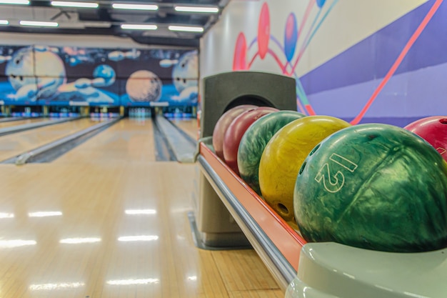 Bowling balls against empty lanes in bowling alley