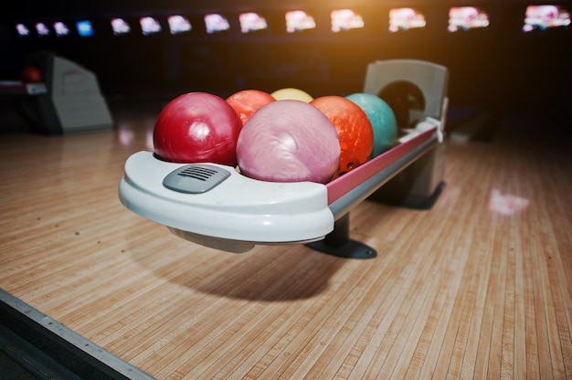 Bowling balls at bowl lift with ultraviolet lighting