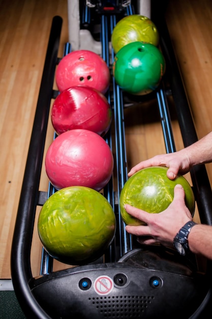 Bowling balls in stand. colored bowling balls at bowling\
alley,relaxing and sport concept.