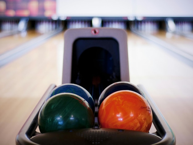 Photo bowling balls at ten pin bowling alley