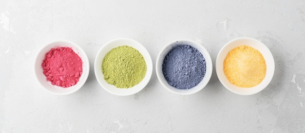 Bowls of multicolored matcha tea powder. Top view.
