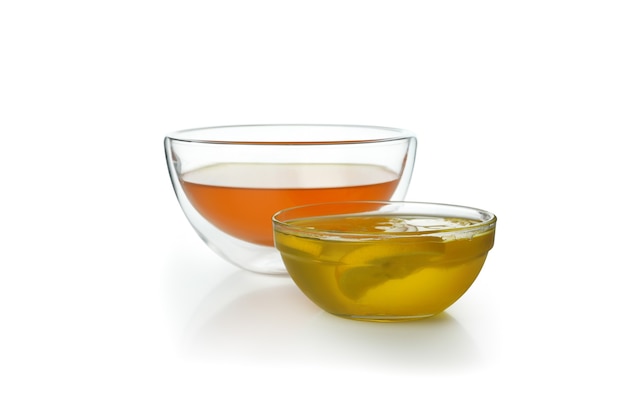 Bowls of orange and lemon jelly isolated on white background