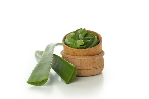 Bowls with aloe slices and leaves isolated on white background