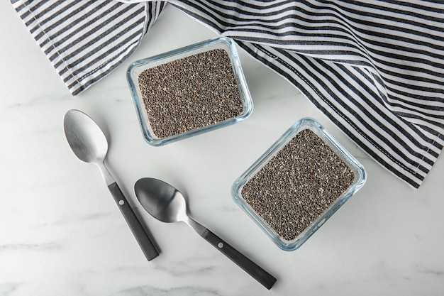 Bowls with chia seeds on table