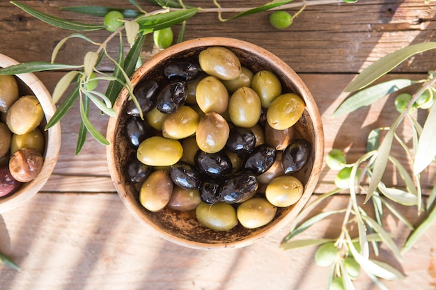 Bowls with different kind of olives : green black kalamata olives with olive oil