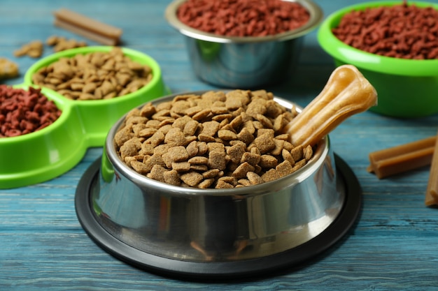 bowls with pet feed on wooden