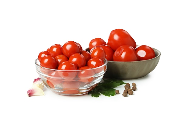 Bowls with pickled tomatoes isolated on white background