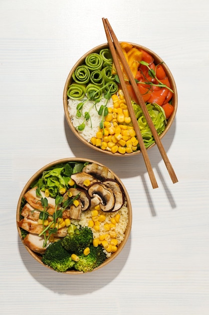 Bowls with tasty and nutritious food top view