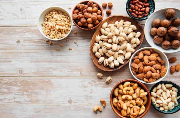 Bowls with various  nuts on a old wooden  background