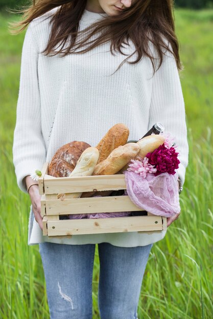 A box of bread in the hands of the girl