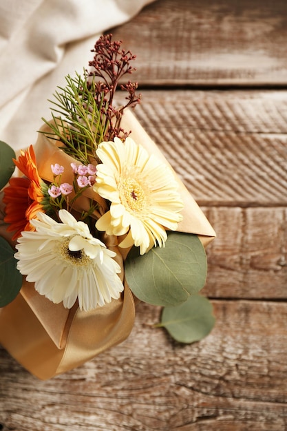 Box decorated with flowers on wooden background