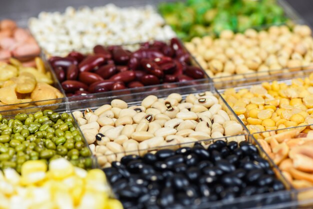 Box of different whole grains beans and legumes seeds lentils and nuts colorful snack  top view 