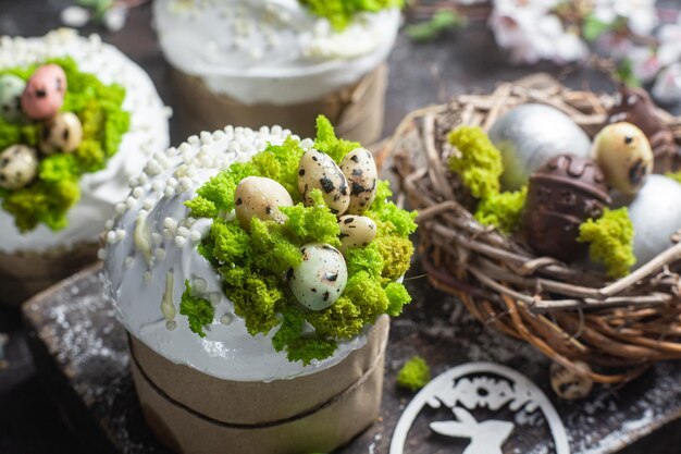 A box of easter eggs with a nest of green and white eggs