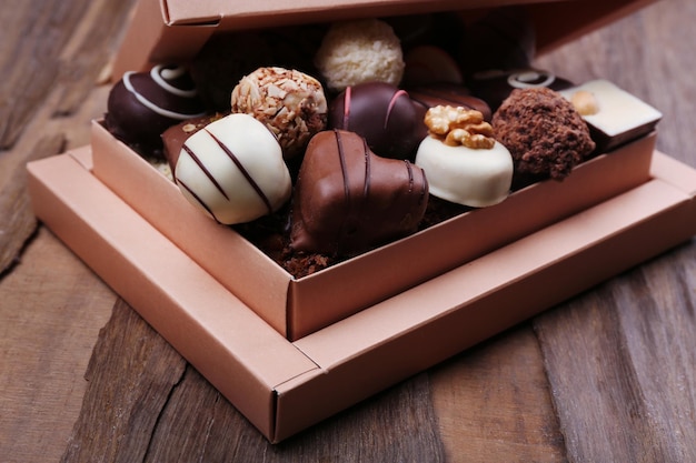 Box filled with chocolates on wooden rustic background