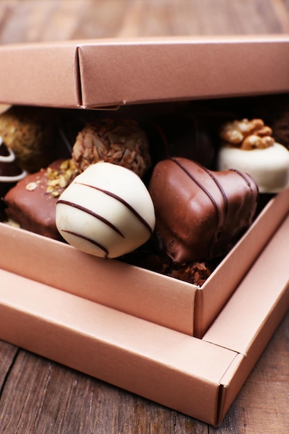 Box filled with chocolates on wooden rustic background