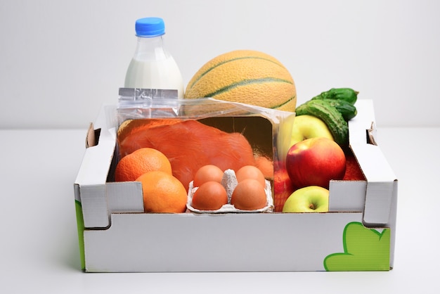 Box full of food in concept donation box isolated on white