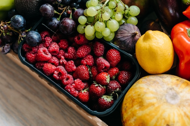 Box full of various organic berries and fruits Food delivery concept