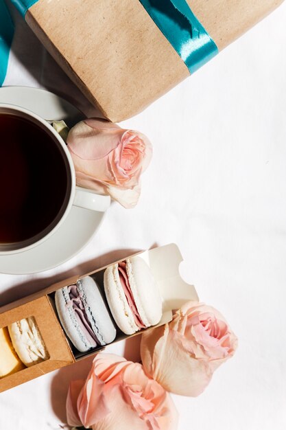 box of macaroons with cup of coffee