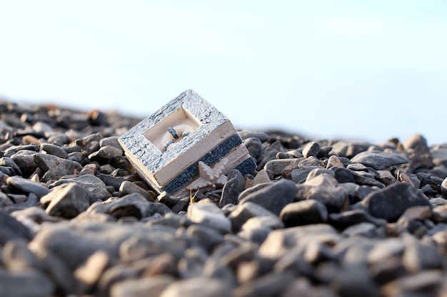 A box on a marine theme stands on a rocky shore