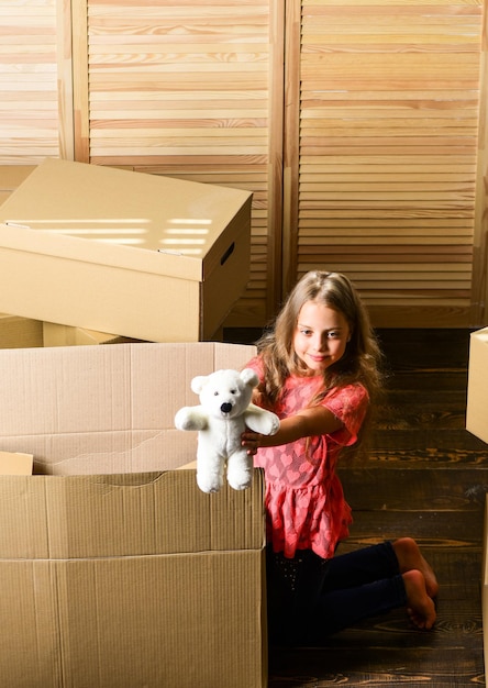 Box package and storage Small child prepare toys for relocation Happy childhood Relocating family stressful for kids Kid girl relocating boxes background Relocating concept Delivery service