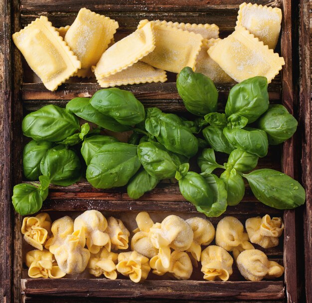 Box of pasta ravioli and basil