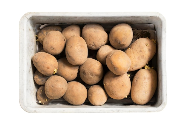 Box of raw unpeeled potatoes isolated on white backgound