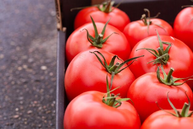 Box of ripe red tomatoes