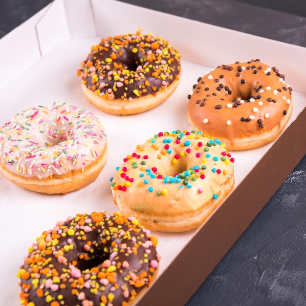 Box of sweet fresh donuts with filling.