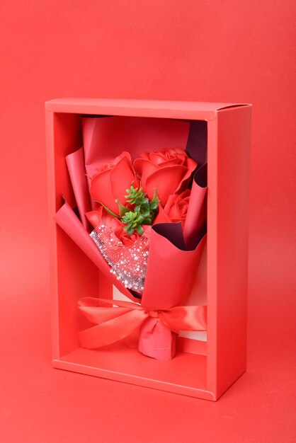 Box with flower gifts on color background top view valentine039s day