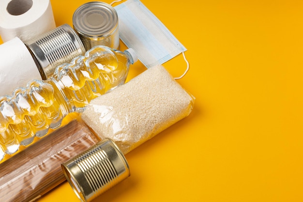 Box with food to support those in need during a pandemic disaster on a bright background