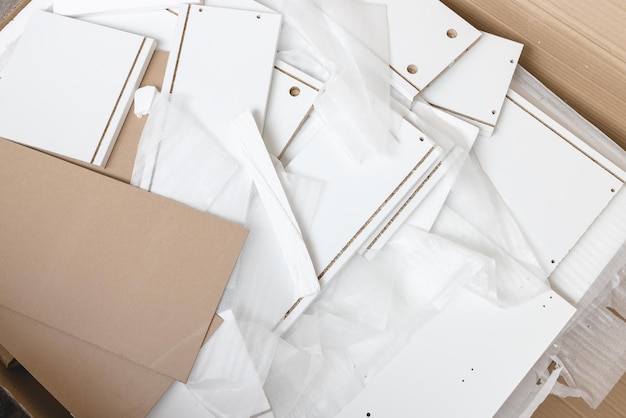 box with furniture assembly parts on the floor