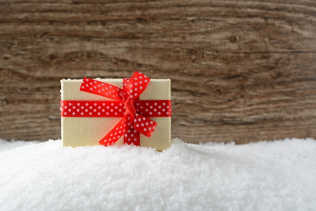 Photo box with a gift on snow