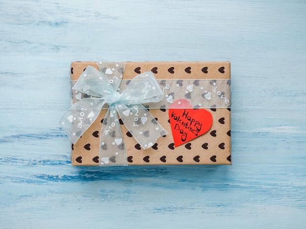 Box with a gift, tied with a ribbon, note with sweet words