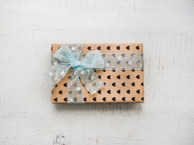 Box with a gift, tied with a ribbon, note with sweet words