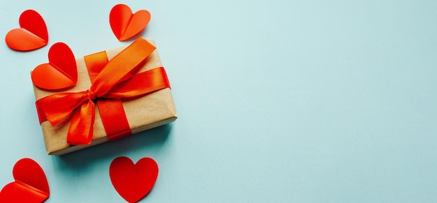 Box with gift valentines day on blue background flatlay concept