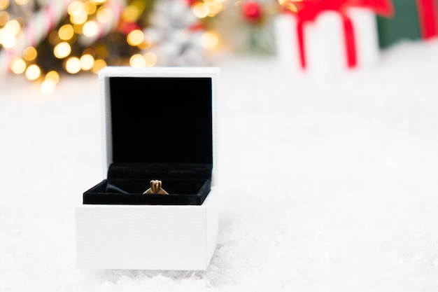 A box with gold ring on the snow