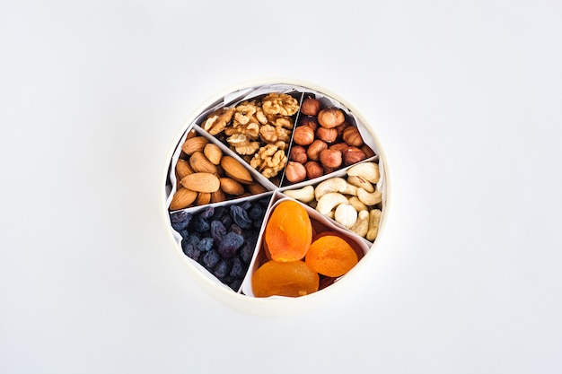 Photo box with nuts and dried fruits, healthy snack, proper nutrition