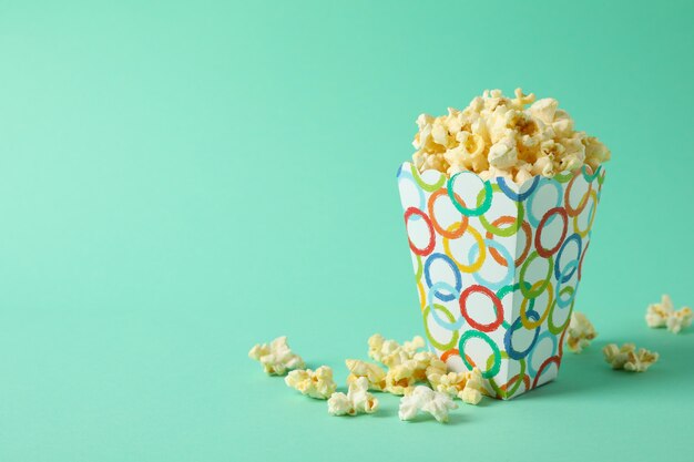 Box with popcorn on mint.