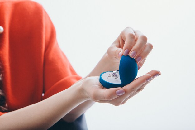 A box with rings in the girl's hand