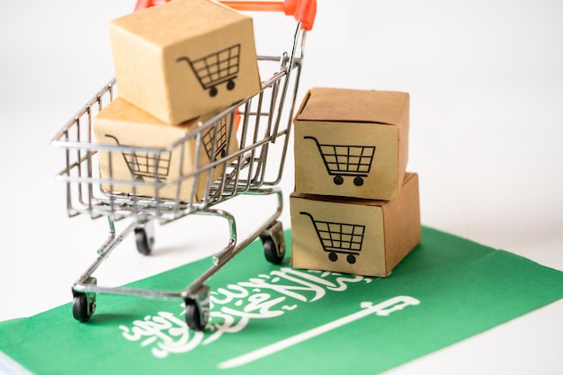 쇼핑 카트 로고와 사우디아라비아 국기가 있는 상자 가져오기 내보내기 쇼핑 온라인 또는 전자 상거래 금융 배달 서비스 저장소 제품 배송 무역 공급자 개념